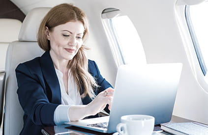 Businesswoman traveling by corporate jet